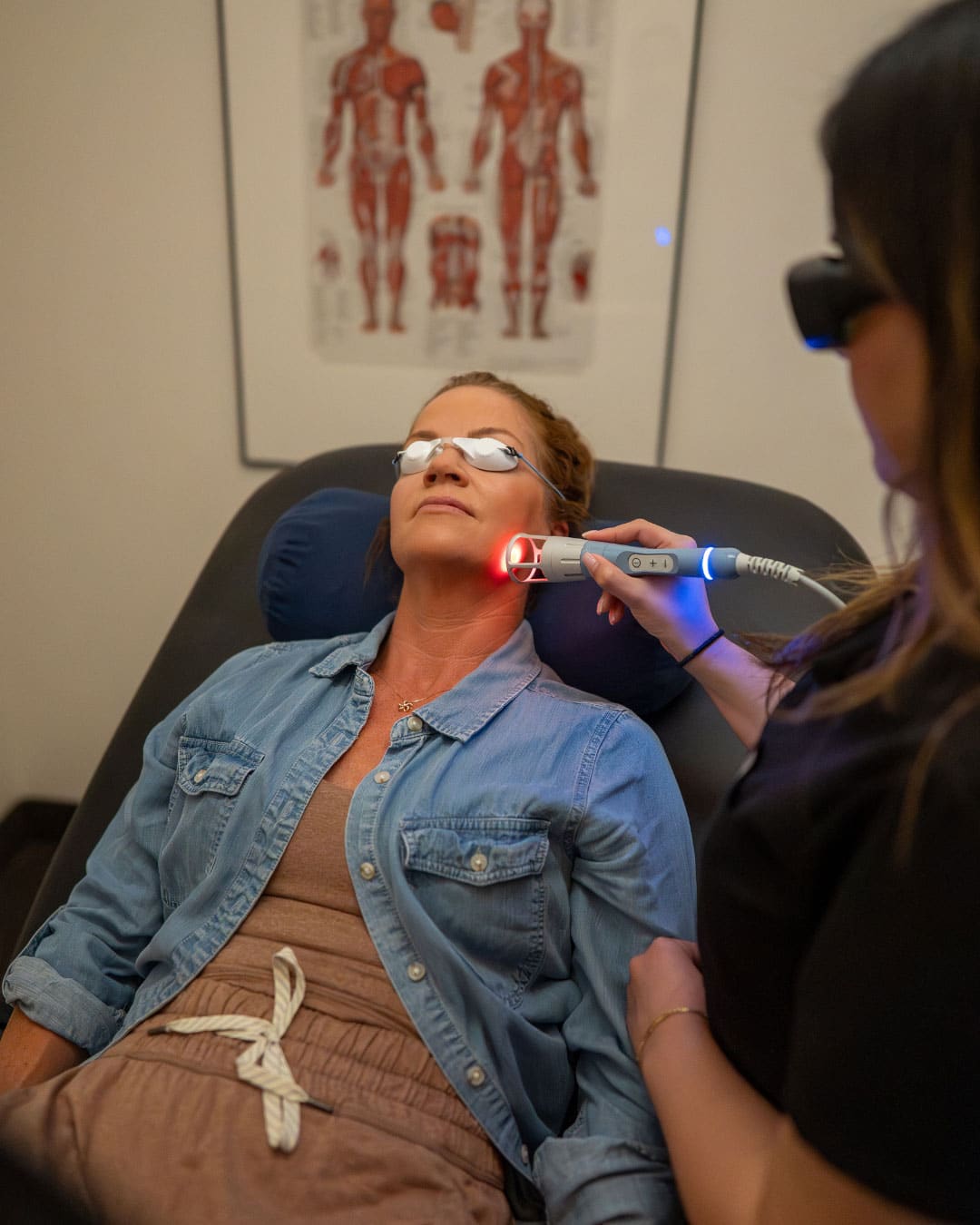 Patient receiving laser therapy treatment for jaw pain in Santa Barbara clinic