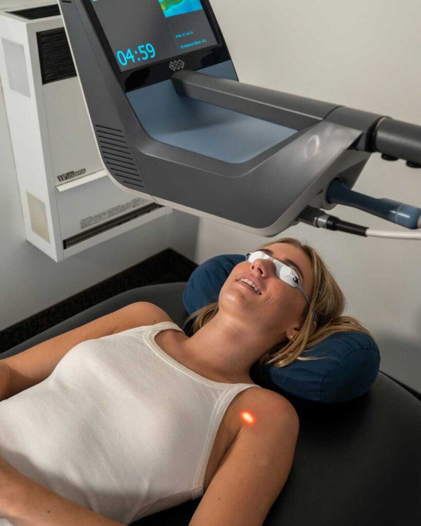 Patient receiving robotic laser therapy for shoulder pain at Bissell Clinic in Montecito, Santa Barbara