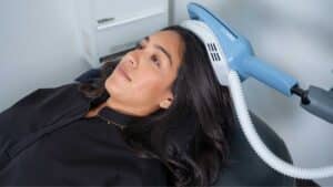 Person receiving an Exomind neurostimulation treatment while reclining in a chair at a wellness clinic in Santa Barbara.